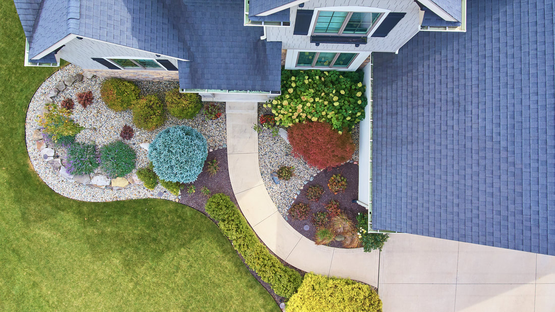 a bird's eye view of a house with landscaping
